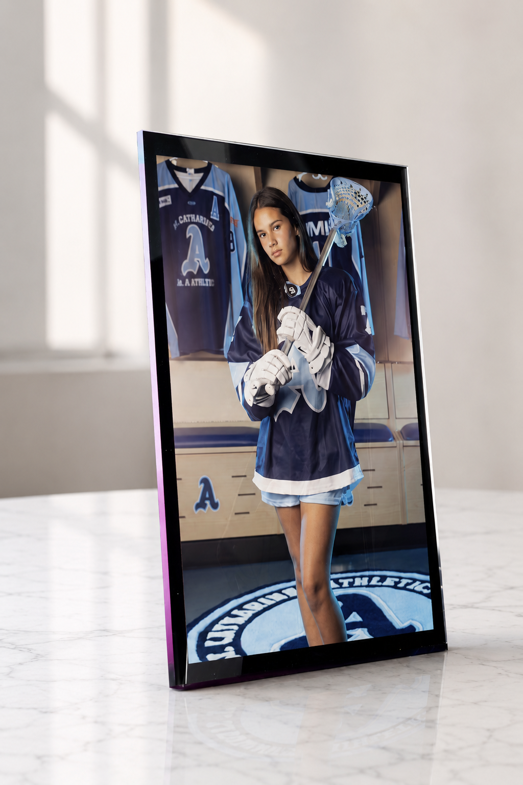 Original black-edged acrylic athlete frame displayed on a marble table