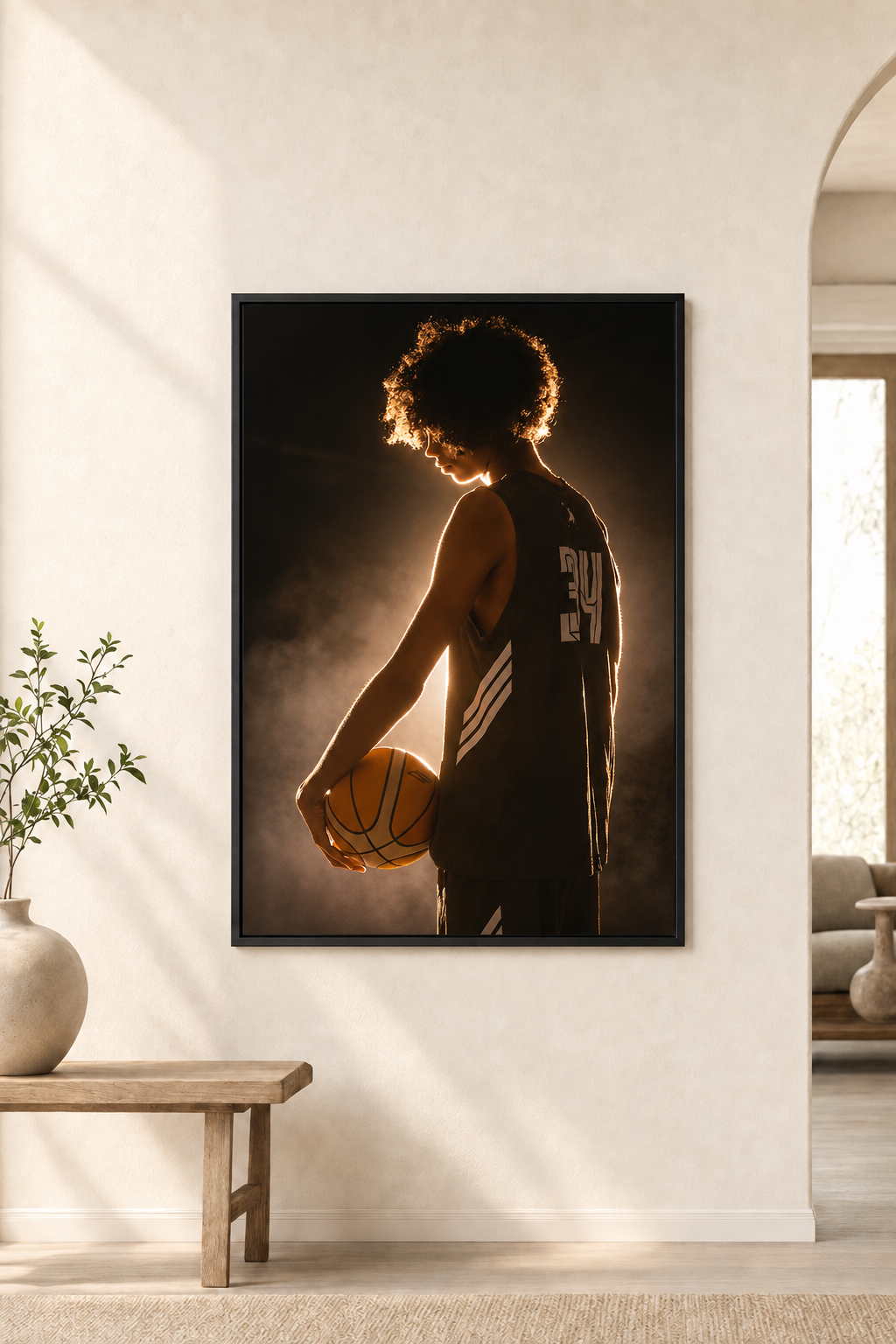 Black-framed basketball portrait mounted flush against a warm ivory wall